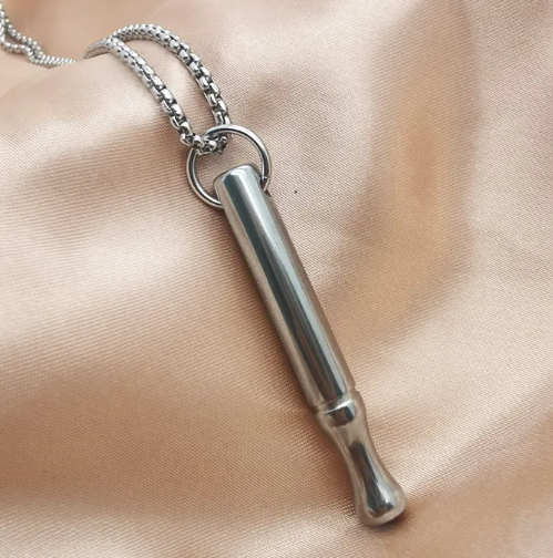 Breathing necklace for anxiety relief, featuring a sleek silver pendant on a black cord, designed for calming and stress reduction.