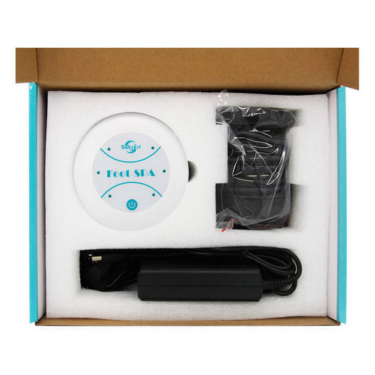 Mini foot massager in a cardboard box, includes a round white device labeled "Foot Spa," power adapter, and cables.