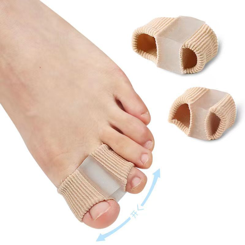 Fiber toe separator in beige, positioned on a foot, with two additional separators displayed beside it.